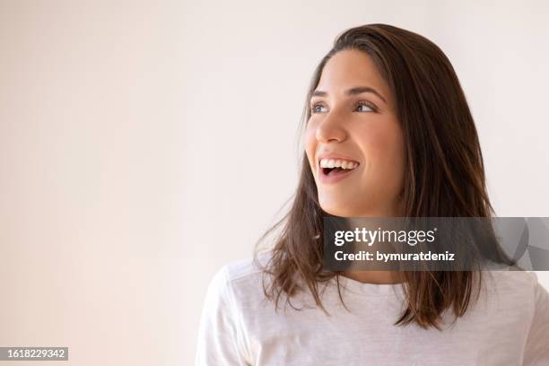 woman smiling and looking up - woman face laughing side stock pictures, royalty-free photos & images