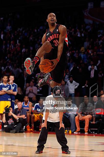 Terrence Ross of the Toronto Raptors jumps over a ball kid in his final dunk during the Sprite Slam Dunk Contest part of 2013 NBA All-Star Weekend at...