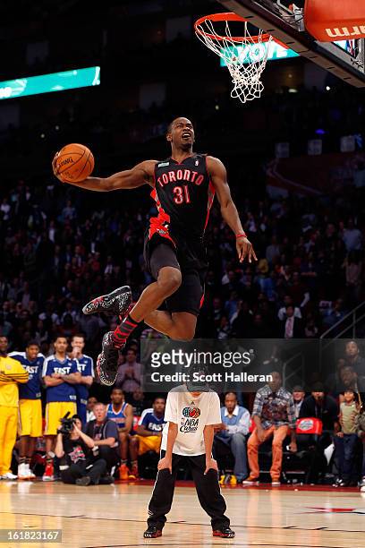 Terrence Ross of the Toronto Raptors jumps over a ball kid in his final dunk during the Sprite Slam Dunk Contest part of 2013 NBA All-Star Weekend at...