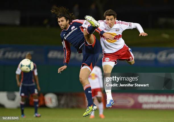 Juan Toja of the New England Revolution and Andrew Ribeiro of the New York Red Bulls collide in the air when jumping for the ball in the second half...