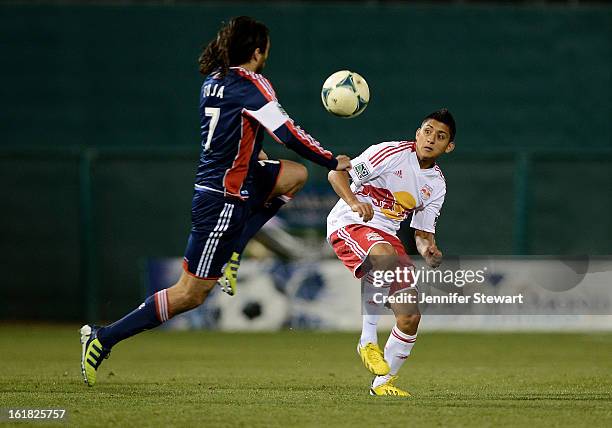 Juan Toja of the New England Revolution lunges for the ball against Amando Moreno of the New York Red Bulls in the first half during FC Tucson Desert...