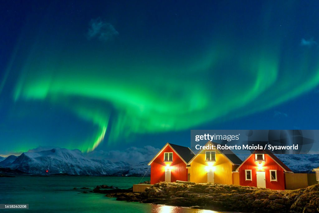 Traditional rorbu during the Northern Lights