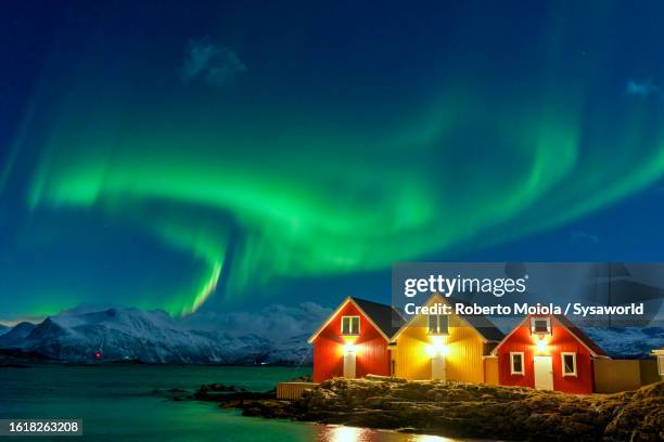 traditional rorbu during the northern lights - noorderlicht stockfoto's en -beelden