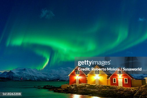 Traditional rorbu during the Northern Lights