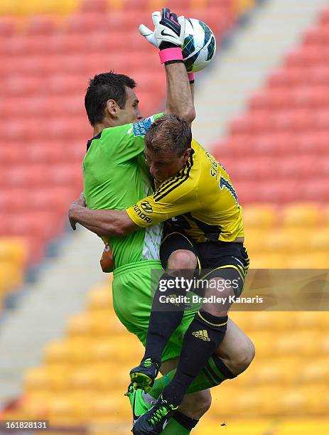 Ben Sigmund of the Phoenix crashes into goal keeper Michael Theo of the Roar during the round 21 A-League match between the Brisbane Roar and the...