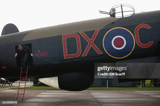 Engineer Keith Breachley exits the Lancaster bomber "Just Jane" which is being restored with the aim of getting it airworthy, at Lincolnshire...