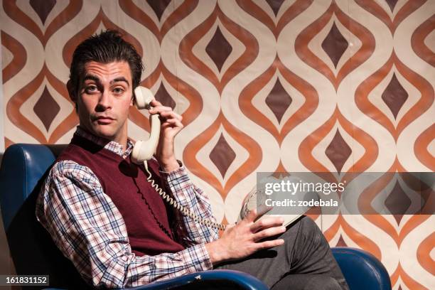 man in retro room answering at the phone - vintage telephone stock pictures, royalty-free photos & images
