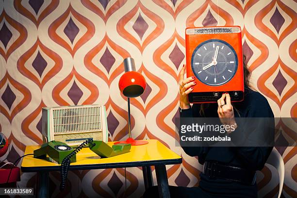 secretary in vintage office holding a clock - clock person desk stockfoto's en -beelden