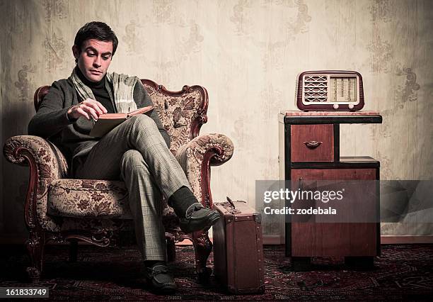 elegant retro man reading a book in vintage room - radio listening stock pictures, royalty-free photos & images