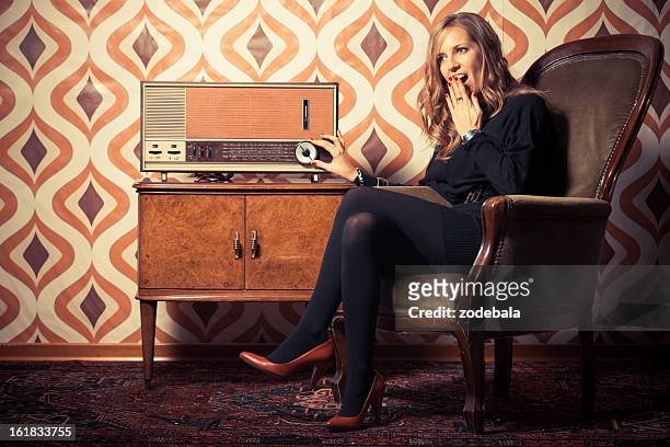 beautiful woman listening news on vintage radio - tuning stock pictures, royalty-free photos & images