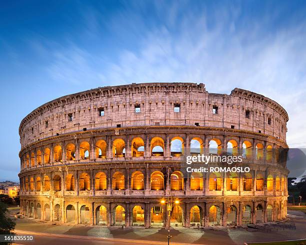 the golden colosseum at dusk in rome, italy  - colosseum rome bildbanksfoton och bilder