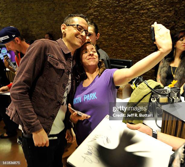 Linkin Park singer Chester Bennington poses with fans during an autograph session at Club Tattoo inside the Miracle Mile Shops at Planet Hollywood...