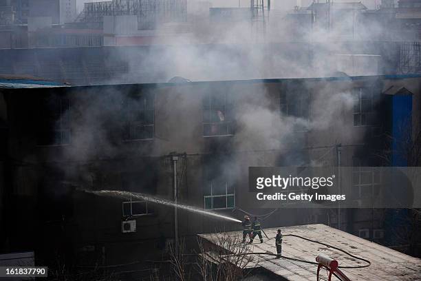 Fire services work at the site of a fire at a supermarket on February 17, 2013 in Changzhi, China. The supermarket caught fire at 4:10 a.m. Today and...