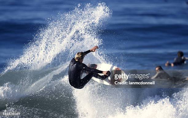 a surfer riding a wave in the ocean - malibu stock pictures, royalty-free photos & images