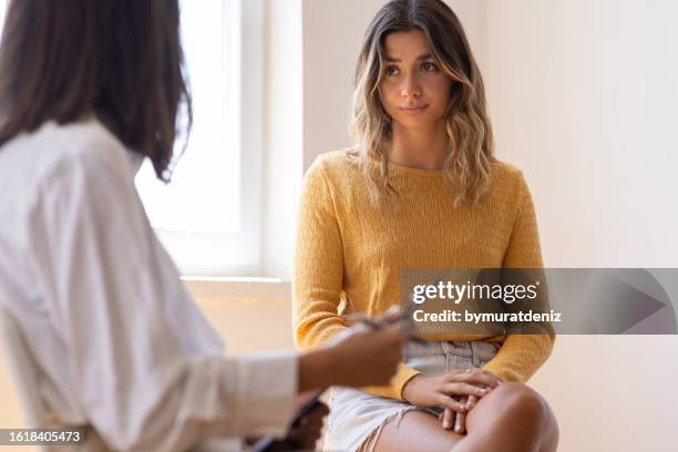 woman having psychotherapy session at psychologist's office - conflict workplace stock pictures, royalty-free photos & images