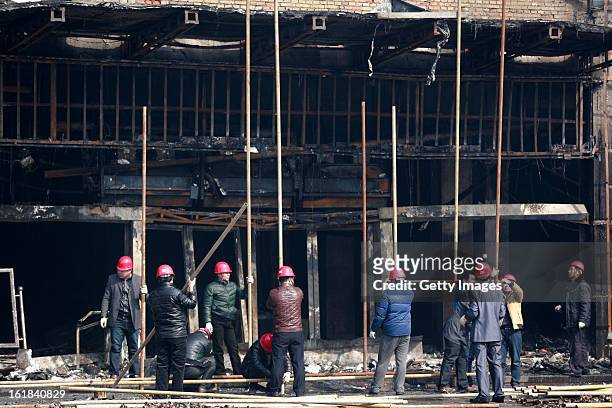 Rescuers work at a fire site at a supermarket on February 17, 2013 in Changzhi, China. The supermarket caught fire at 4:10 a.m. Today and was put out...