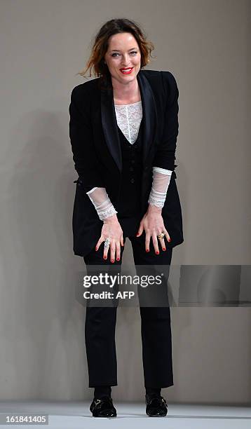 Designer Alice Temperley greets the audience after the show for her label Temperley London during the 2013 Autumn/Winter London Fashion Week in...