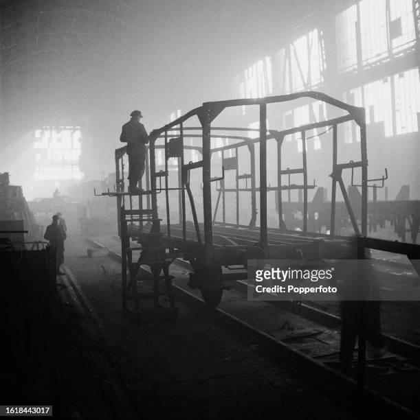 Employees repair and restore tram cars and railway wagons in one of the two reconstructed halls of the AEG turbine factory in Berlin in...