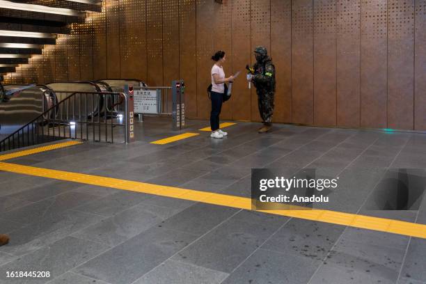 Soldier and a woman are seen during the evacuation test at Gwanghwamun Plaza/Station in Seoul, South Korea on August 23, 2023. South Korea hold its...