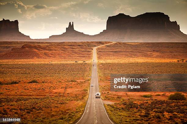 rv drives down the highway - tumble weed stock pictures, royalty-free photos & images