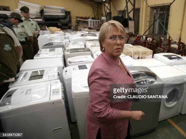Chilean President Michelle Bachelet visits the police headquarters in Concepcion to see the recovered objects that had been looted after the...