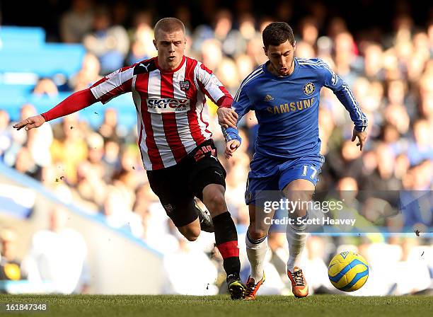 Eden Hazard of Chelsea in action with Jake Bidwell of Brentford during the FA Cup Fourth Round Replay between Chelsea and Brentford at Stamford...