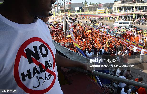 Supporter of nationalist Buddhist monks wears a T-shirt calling for a ban on Islamic halal-slaughtered meat, during a rally at Maharagama, a suburb...