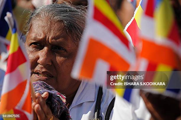 Supporter of nationalist Buddhist monks prays during a rally calling for a ban on Islamic halal-slaughtered meat at Maharagama, a suburb of the...