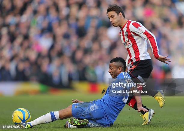 Ashley Cole of Chelsea slides in a tackle against Sam Saunders of Brentford during the FA Cup Fourth Round Replay match between Chelsea and Brentford...