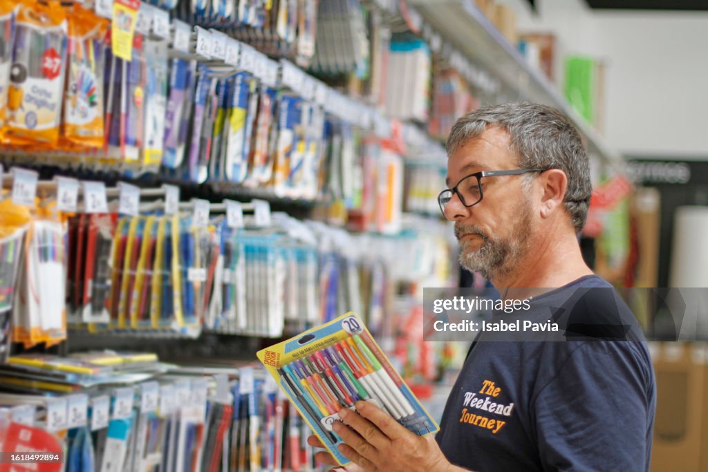 Man looking for school supplies in a stationery store