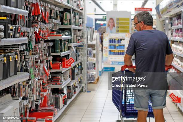 man looking for tools at hardware store - hardware shop stock pictures, royalty-free photos & images