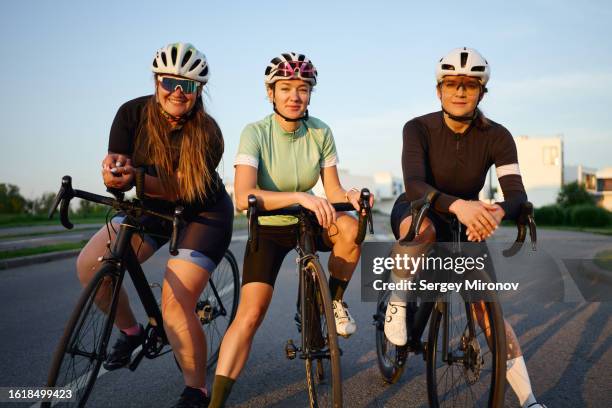 female friends cyclists - cycling helmet stock pictures, royalty-free photos & images