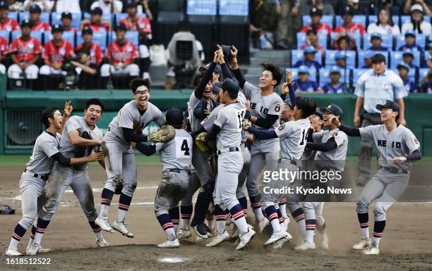 Players of Keio high school celebrate after beating Sendai Ikuei high school 8-2 in Japan's summer national high school baseball championship final...