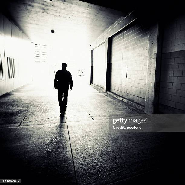 backstreet walk - man walking silhouette stock pictures, royalty-free photos & images