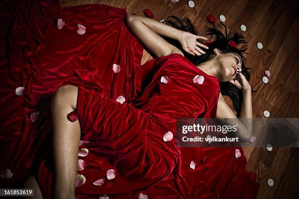young beautiful lady - rose pedals bed stock pictures, royalty-free photos & images