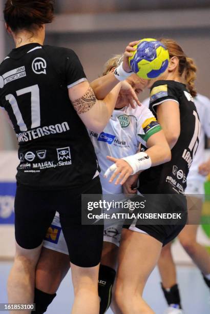 Hungarian Piroska Szamoransky of FTC Rail Cargo Hungaria is pushed by Slovenian Barbara Varlec-Lazovic and Linnea Torstensson of RK Krim Mercator in...