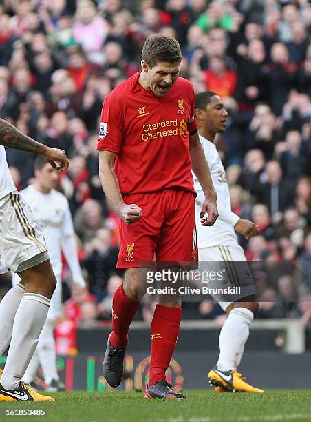 Steven Gerrard of Liverpool celebrates after scoring the first goal from the penalty spot during the Barclays Premier League match between Liverpool...