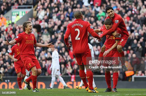 Steven Gerrard of Liverpool celebrates with Luis Suarez,Glen Johnson and Lucas after scoring the first goal from the penalty spot during the Barclays...