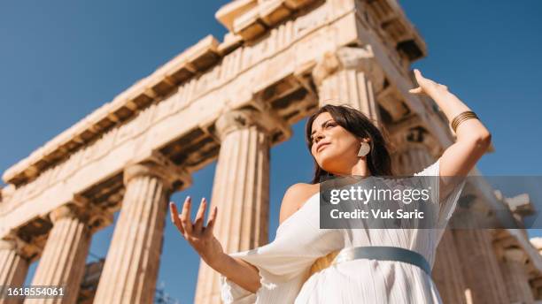 woman posing in front of parthenon - acropolis athens stock pictures, royalty-free photos & images