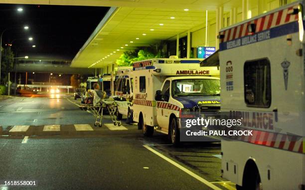 Ambulances are lined up outside the International Terminal as hospitals are being evacuated to Brisbane ahead of Cyclone Yasi at Cairns Airport on...
