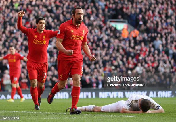 Jose Enrique of Liverpool celebrates with Luis Suarez after scoring the third goal during the Barclays Premier League match between Liverpool and...