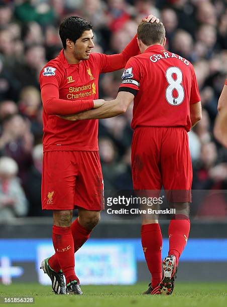 Luis Suarez of Liverpool celebrates with Steven Gerrard after scoring the fourth goal during the Barclays Premier League match between Liverpool and...