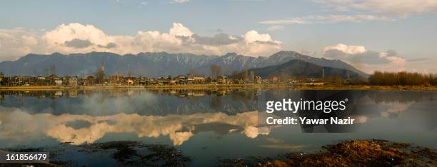 The Zabarvan Mountains are reflected on the waters of Barari Numbal Lagoon during a strike call given by separatists against the execution of alleged...