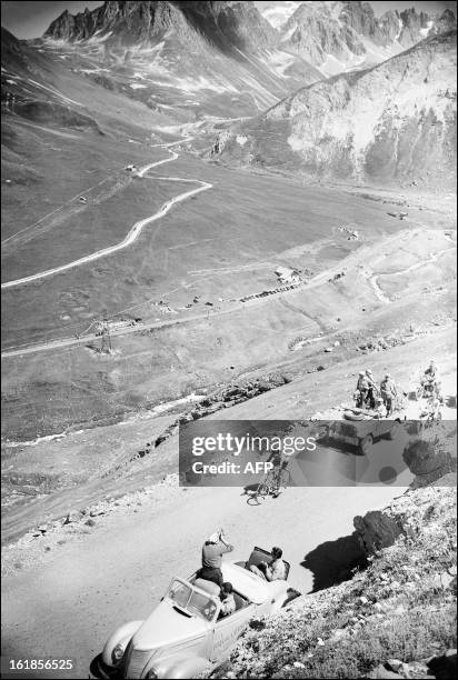 Italian cyclist Fausto Coppi rides uphill in the Col du Galibier on July 6 during the 11th stage of the Tour de France between Bourg d'Oisans and...