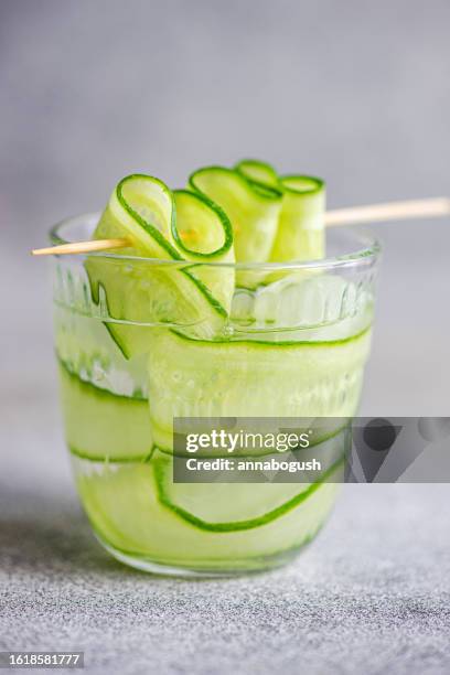 glass of cucumber water or a cucumber cocktail on a table - cucumber cocktail stock pictures, royalty-free photos & images