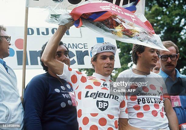 Lucien Van Impe from Belgium, wearing the red and white Polka Dot Jersey of the best climber, waves from podium during the 64th Tour de France...