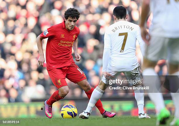 Philippe Coutinho of Liverpool attempts to move past Leon Britton of Swansea during the Barclays Premier League match between Liverpool and Swansea...