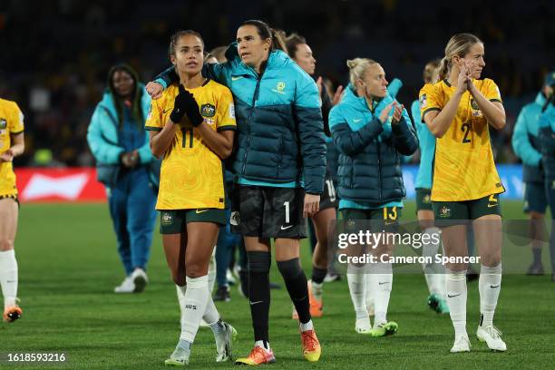 Mary Fowler of Australia is embraced by Lydia Williams as players of Australia applaud the fans after defeat to England during the FIFA Women's World...