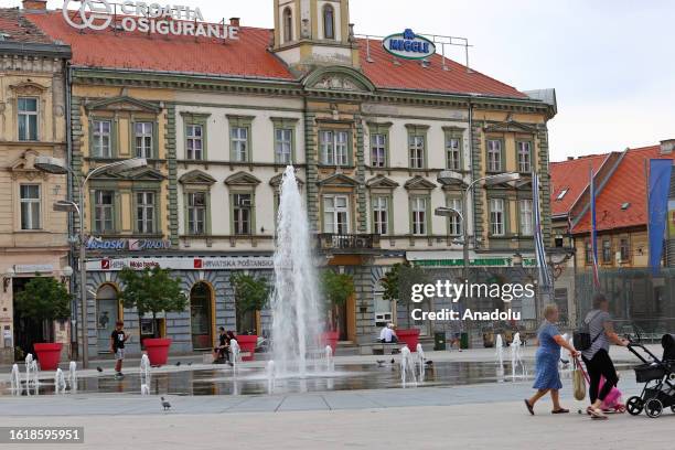People walk on the street as daily life continues in the 4th biggest city of Croatia, Osijek on August 16, 2023.