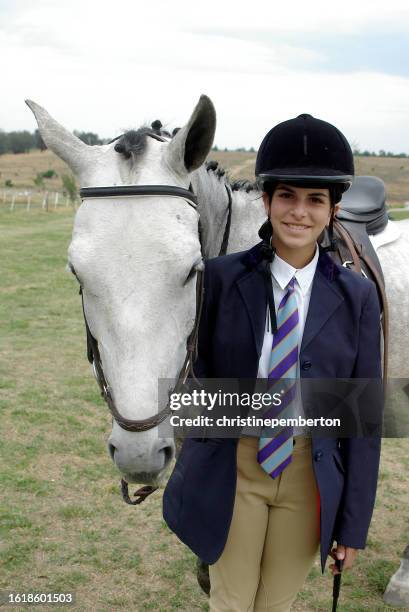 portrait of a teenage girl standing with her horse before a competition - riding hat stock pictures, royalty-free photos & images